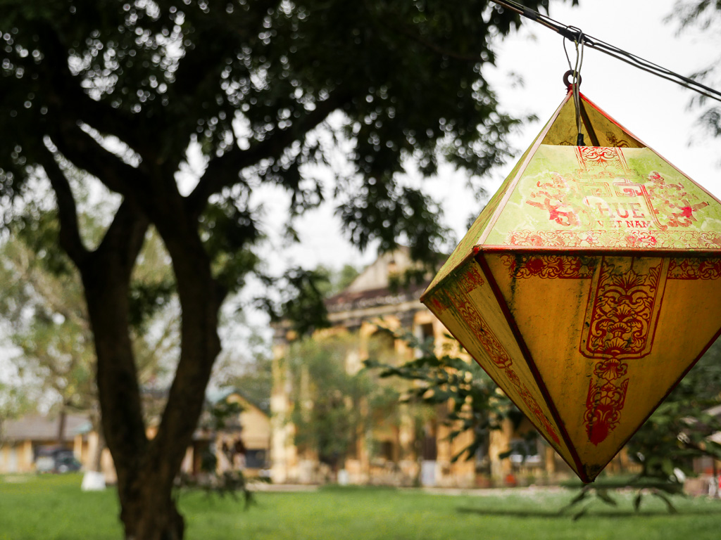 A red and yellow lantern with the words "Hue Vietnam" written on it.