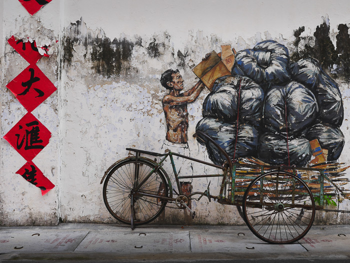 A mural of a man collecting rubbish.