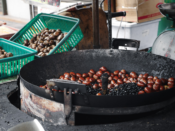 Chestnuts roasting in a pan.