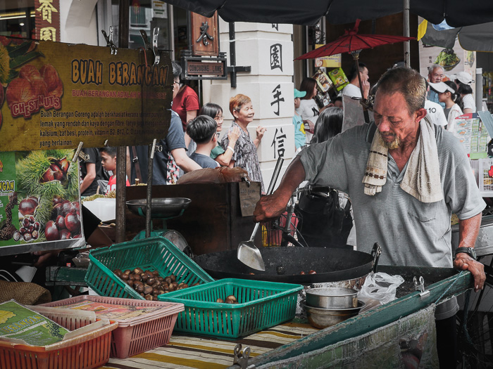 Man roasting chestnuts on the street.