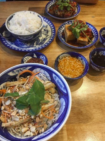 Vegan Vietnam, Hue: bowls of rice, noodles and vegetables with peanut sauce in a vietnamese restaurant.